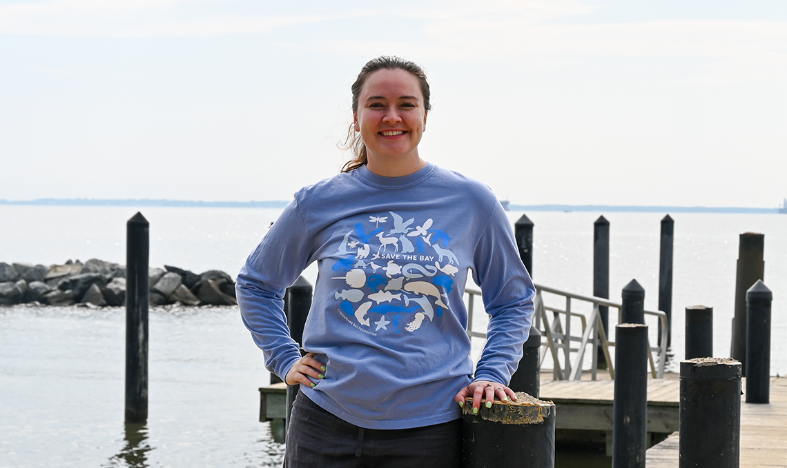 Woman wearing our new blue critter tee featuring critters found in the bay