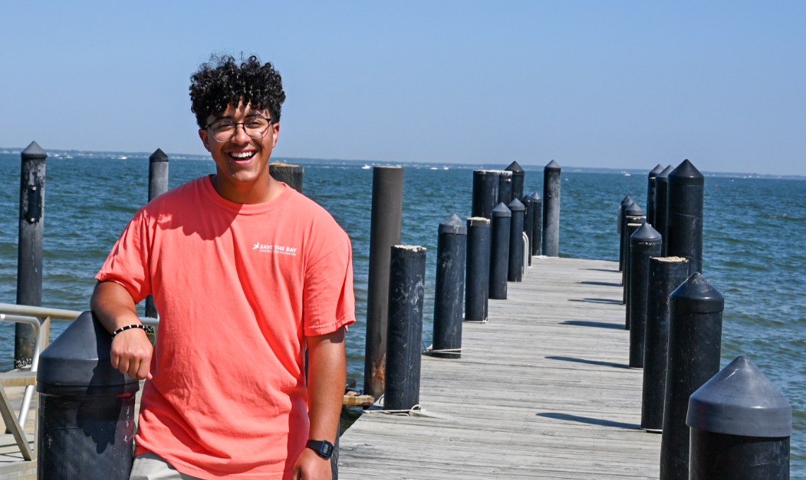 Man wearing our new Summer Color Bayside T-shirt - Salmon? Save the Bay - Shop All!